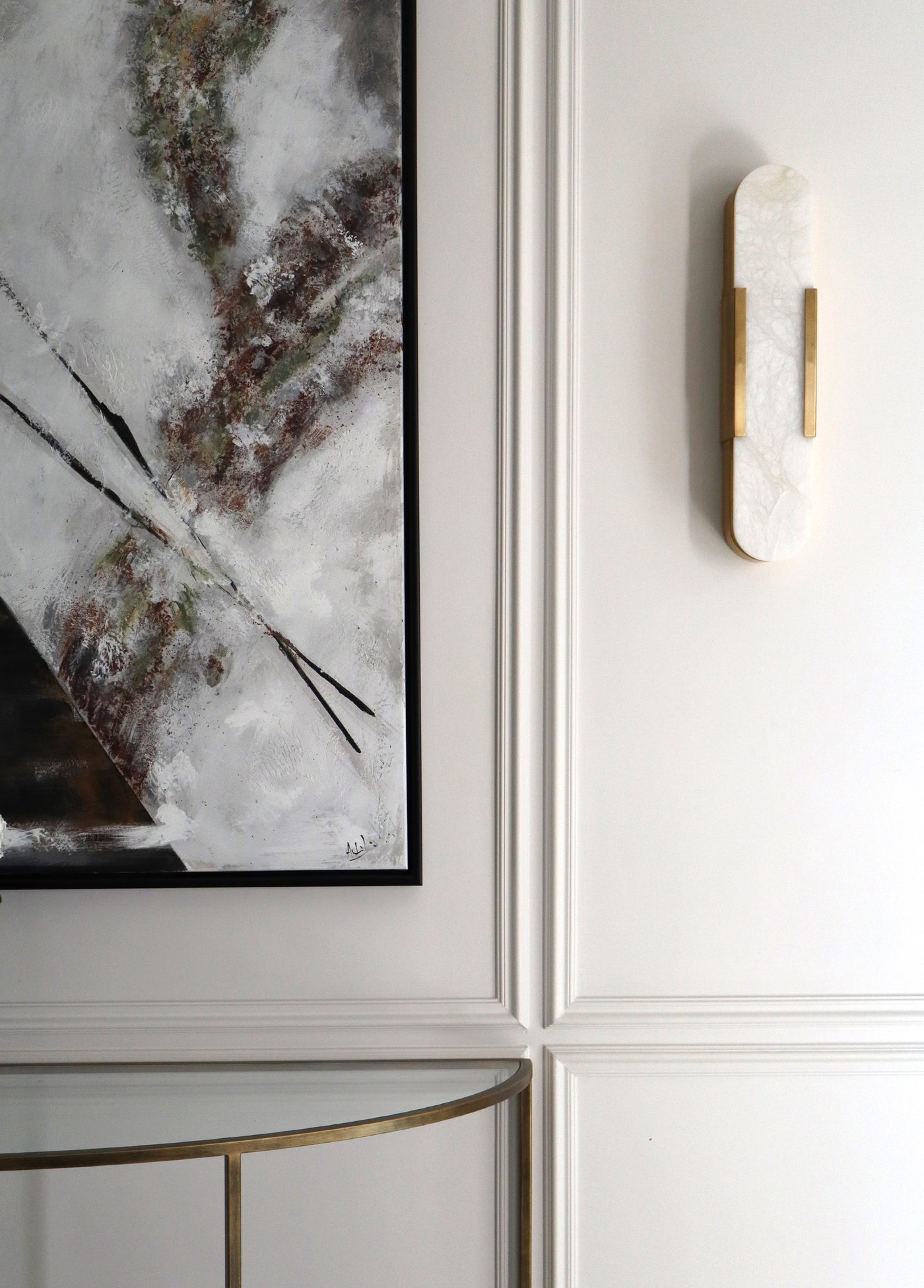 Alabaster wall sconce beside abstract artwork