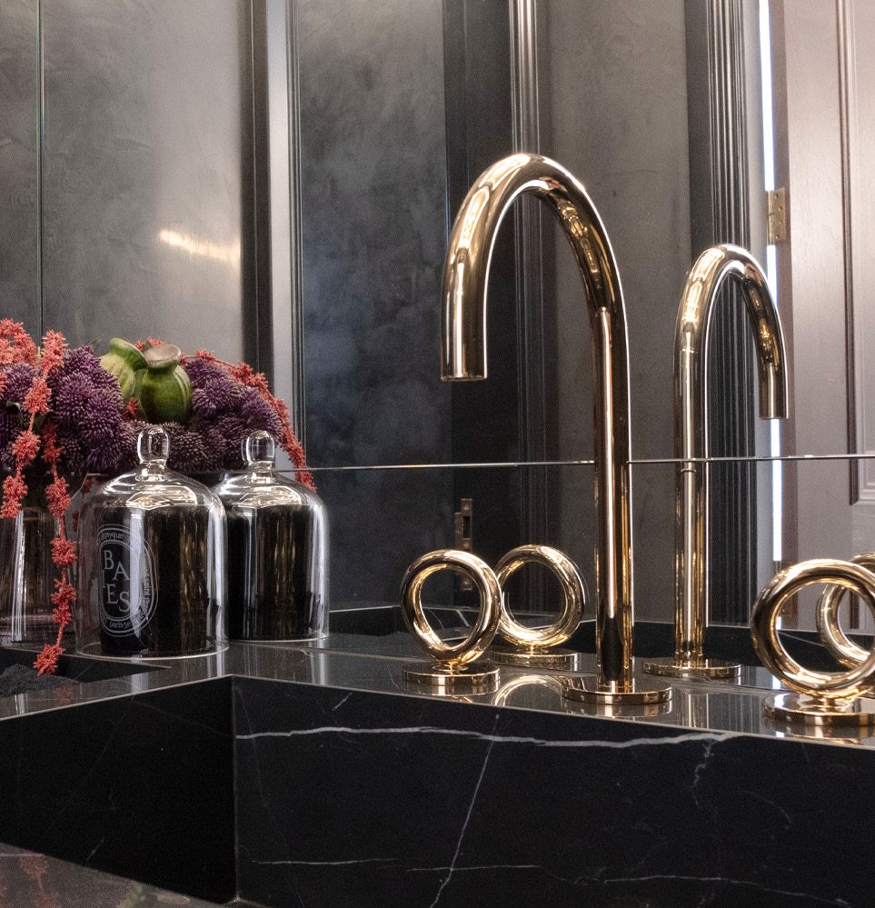 Powder room vanity in black marble with 24K gold taps